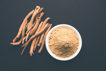 Ashwagandha / Aswaganda OR Indian Ginseng is an Ayurveda medicine in stem and powder form. Isolated on plain background. selective focus