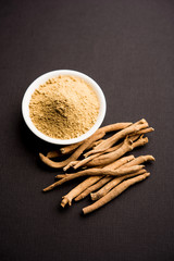 Ashwagandha / Aswaganda OR Indian Ginseng is an Ayurveda medicine in stem and powder form. Isolated on plain background. selective focus