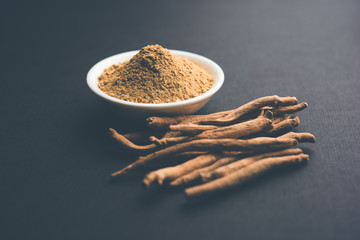 Ashwagandha / Aswaganda OR Indian Ginseng is an Ayurveda medicine in stem and powder form. Isolated on plain background. selective focus