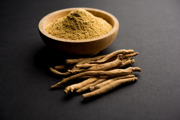 Ashwagandha / Aswaganda OR Indian Ginseng is an Ayurveda medicine in stem and powder form. Isolated on plain background. selective focus