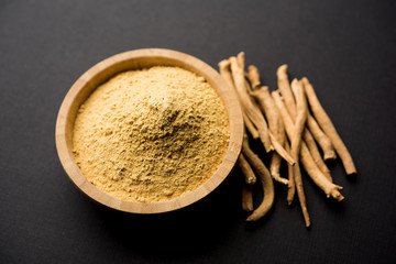 Ashwagandha / Aswaganda OR Indian Ginseng is an Ayurveda medicine in stem and powder form. Isolated on plain background. selective focus