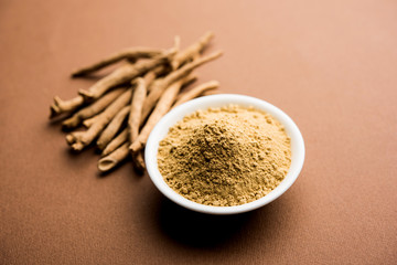 Ashwagandha / Aswaganda OR Indian Ginseng is an Ayurveda medicine in stem and powder form. Isolated on plain background. selective focus