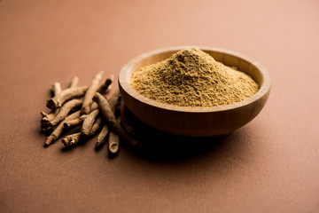 Ashwagandha / Aswaganda OR Indian Ginseng is an Ayurveda medicine in stem and powder form. Isolated on plain background. selective focus