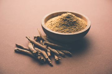 Ashwagandha / Aswaganda OR Indian Ginseng is an Ayurveda medicine in stem and powder form. Isolated on plain background. selective focus