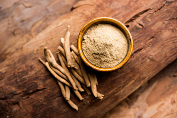 Ashwagandha / Aswaganda OR Indian Ginseng is an Ayurveda medicine in stem and powder form. Isolated on plain background. selective focus