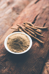 Ashwagandha / Aswaganda OR Indian Ginseng is an Ayurveda medicine in stem and powder form. Isolated on plain background. selective focus
