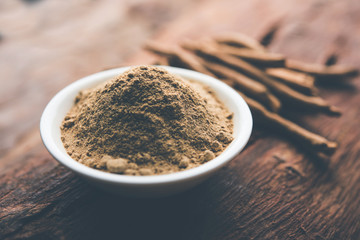 Ashwagandha / Aswaganda OR Indian Ginseng is an Ayurveda medicine in stem and powder form. Isolated on plain background. selective focus