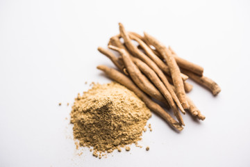 Ashwagandha / Aswaganda OR Indian Ginseng is an Ayurveda medicine in stem and powder form. Isolated on plain background. selective focus