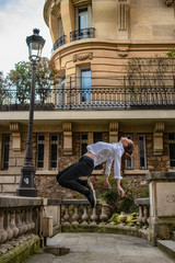 young man floating in paris streets