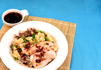 Steamed Rice Noodle roll or rice noodle paste with bean sprout with many topping and black sweet sauce.