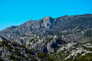 Fototapeta na wymiar Dabarski Kukovi on Velebit close do Karlobag, Croatia, are a ridge composed of steep peaks, which are unique geologic formation. They are famous for hiking and free climbing on huge rock faces. 