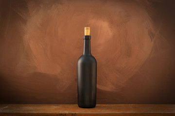 Red wine bottle on a wooden background