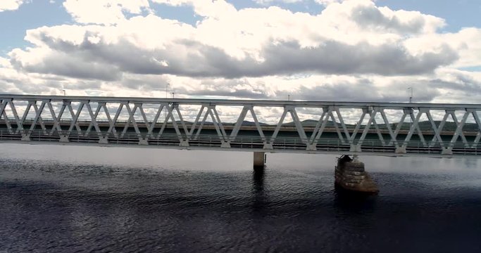 Flying on the side of the steel railroad bridge on a summer day at Kemijärvi Finland
