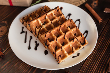Tasty fresh Vienna wafers, jam and cup of coffee on a dark wooden background