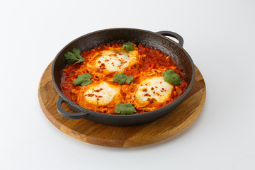 scrambled eggs in tomato sauce isolated on white background