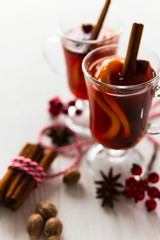 Two glass of mulled wine on the white wooden table