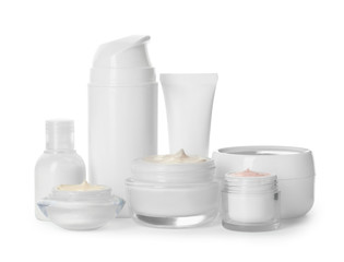 Different containers with hand cream and other cosmetic on white background