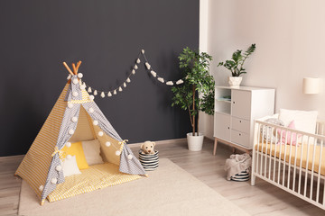 Cozy baby room interior with play tent and crib