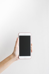 Asian woman's hands holding white smart phone