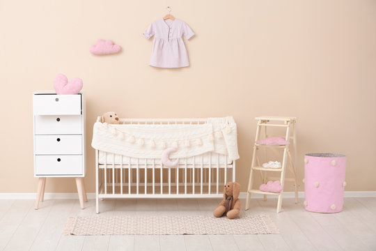 Stylish baby room interior with comfortable crib