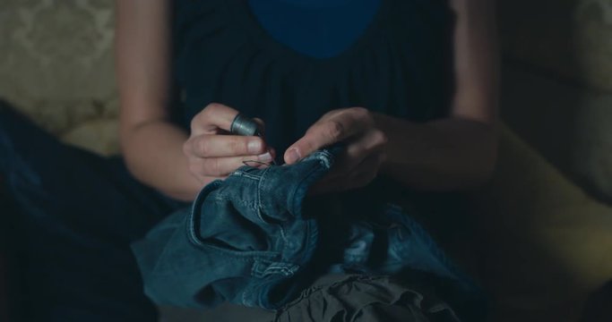 Young woman sewing at home