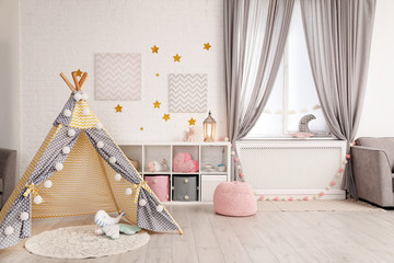 Obraz na płótnie Canvas Cozy kids room interior with play tent and toys