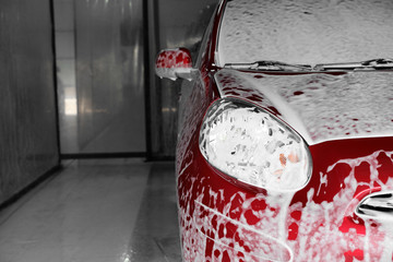 Auto covered with foam at car wash, closeup. Space for text