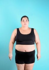 Fototapeta na wymiar Overweight woman before weight loss on color background