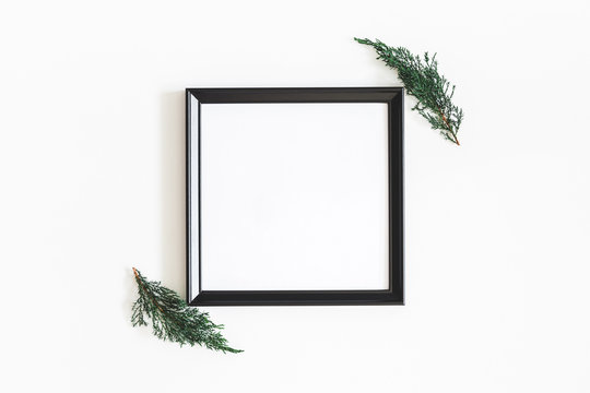 Christmas composition. Photo frame, fir tree branches on white background. Christmas, winter, new year concept. Flat lay, top view, copy space, square
