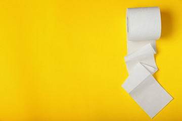 Roll of toilet paper on color background, top view. Space for text