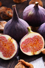 Composition with fresh and dried figs on wooden table