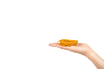 Yellow rubber bands close up with hand isolated on white background, copy space template.