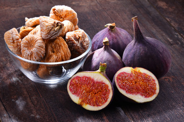 Composition with fresh and dried figs on wooden table