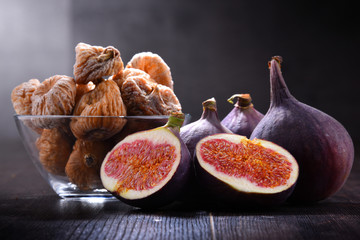 Composition with fresh and dried figs on wooden table