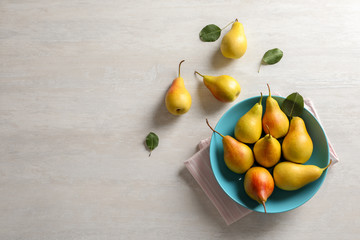 Flat lay composition with ripe pears on light background. Space for text