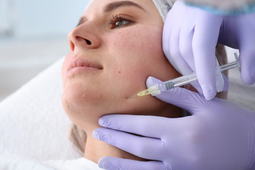 Woman undergoing face biorevitalization procedure in salon, closeup. Cosmetic treatment