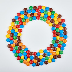Abstract pattern with round color candy on background. Colorful sweets top view. Flat lay image