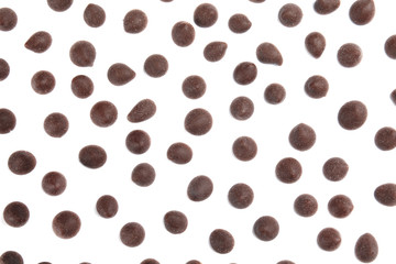 Delicious dark chocolate chips on white background, flat lay