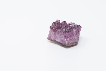Amethyst, a violet variety of quartz, isolated on light background.