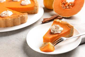 Naklejka na ściany i meble Plate with piece of fresh delicious homemade pumpkin pie on light table