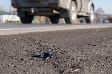 Lost bunch of keys lying on the side of the road near the asphalt pavement of the roadway