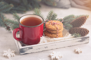 Christmas and New Year composition, mug with tea, home baked orange and chocolate biscuits