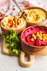 Different hummus bowls. Chickpea hummus, avocado hummus and beetroot hummus.