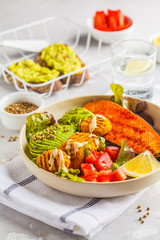 Vegan Rainbow bowl: vegetable meatballs, avocado, sweet potato and salad.