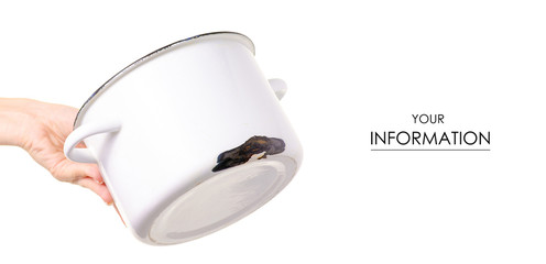 Old enamel saucepan battered in hand pattern on white background isolation