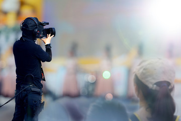 professional cameraman on stage to record event