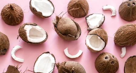 Coconut halves on pink background