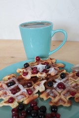 Homemade cranberry waffles and a cup of coffee.