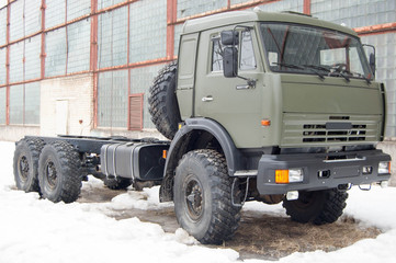 Fototapeta na wymiar Russian diesel , green, new truck in winter day.