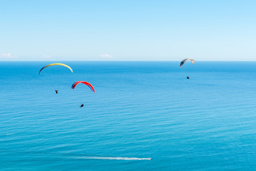 Three tandem paragliders above Sea Point